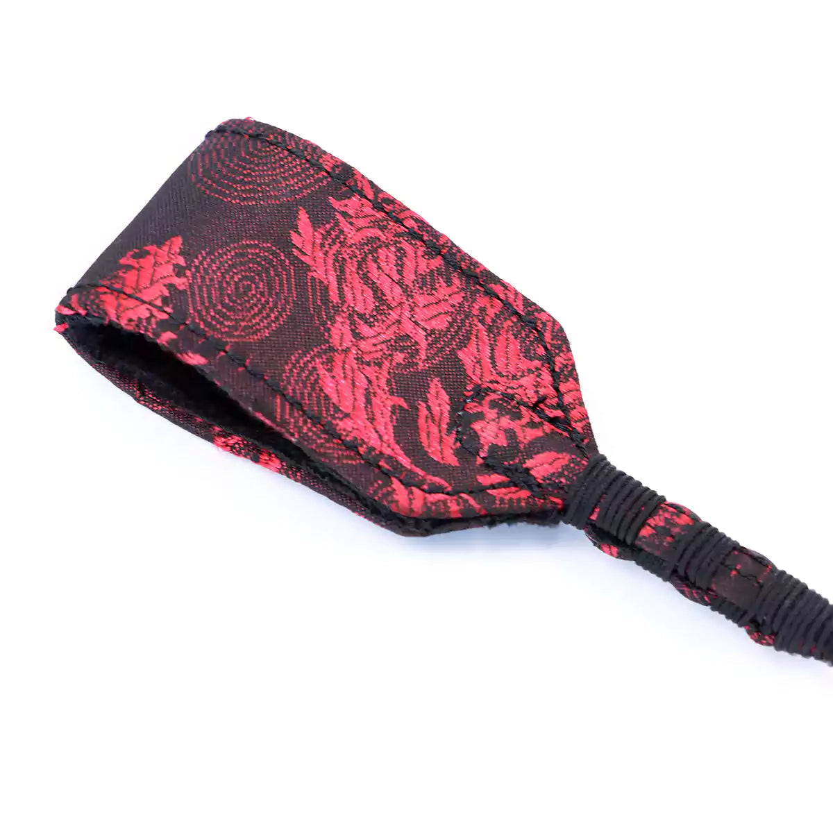 Close-up of Chinese classical embroidery pattern on red riding crop tip