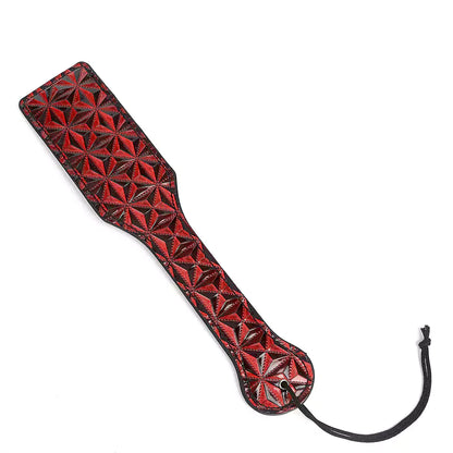 Red Diamond Pattern Leather Spanking Paddle isolated studio view