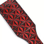 Full view of red diamond-textured paddle face on faux leather paddle