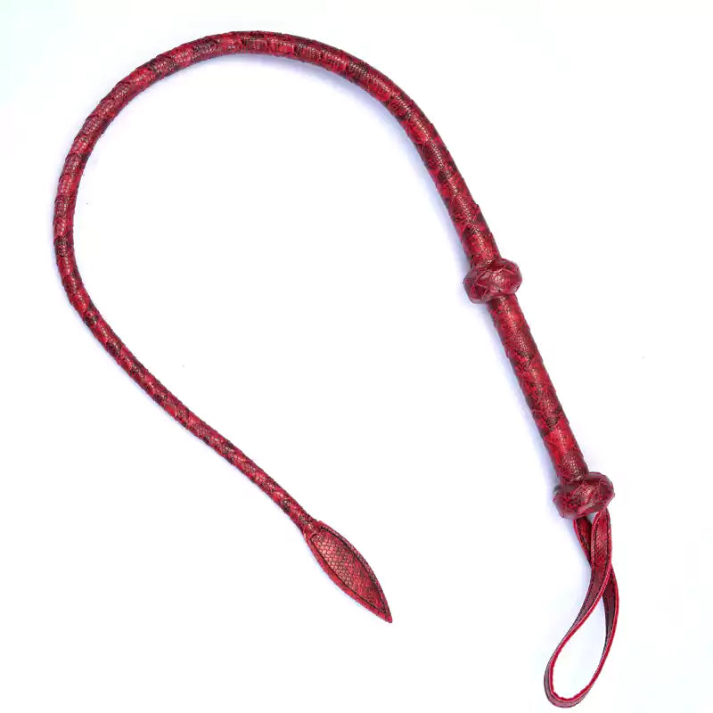 Full view of red embossed faux leather whip on white