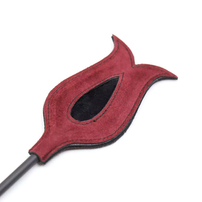 Close-up of red suede slapper head on feather teasing BDSM crop