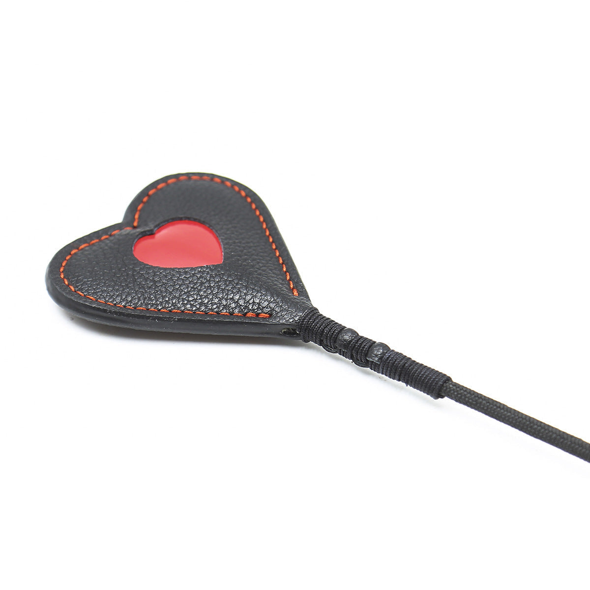 Close-up detail of the black faux leather paddle head on the red heart riding crop