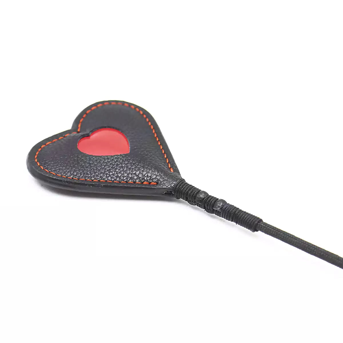 Close-up of bold red heart-shaped faux leather tip on riding crop