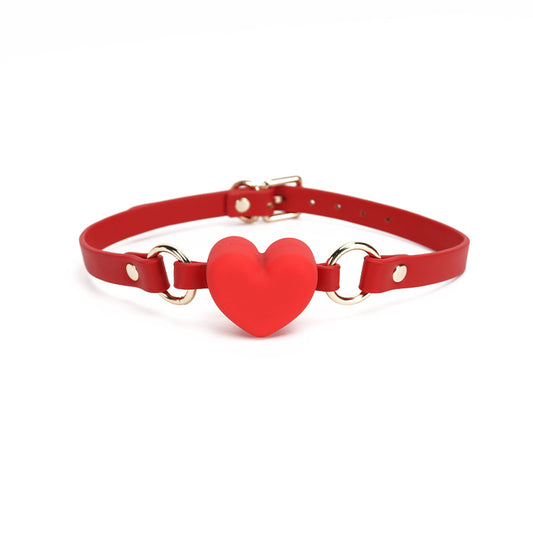 Front view of the red heart-shaped silicone ball gag with wide strap