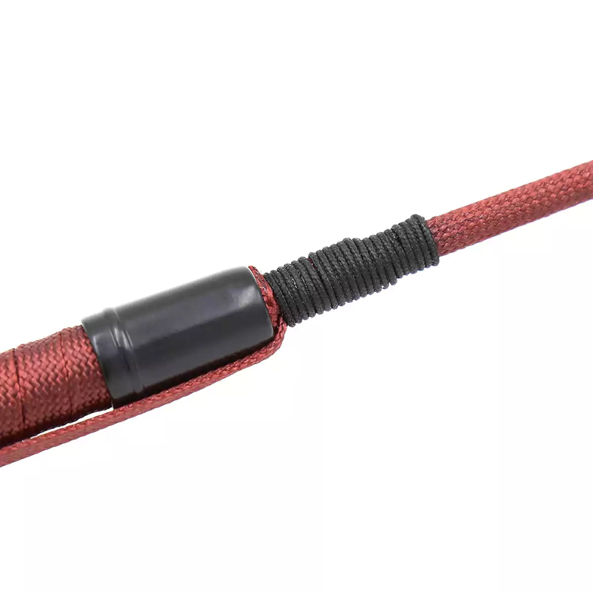 Close-up of shaft texture on red long riding crop