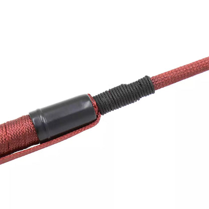 Close-up of shaft texture on red long riding crop