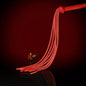 full red leather nine-tail flogger with leaf-shaped tips