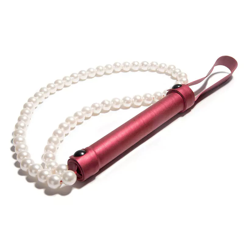 Red pearl BDSM whip on white background