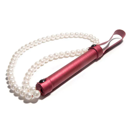 Red pearl BDSM whip on white background