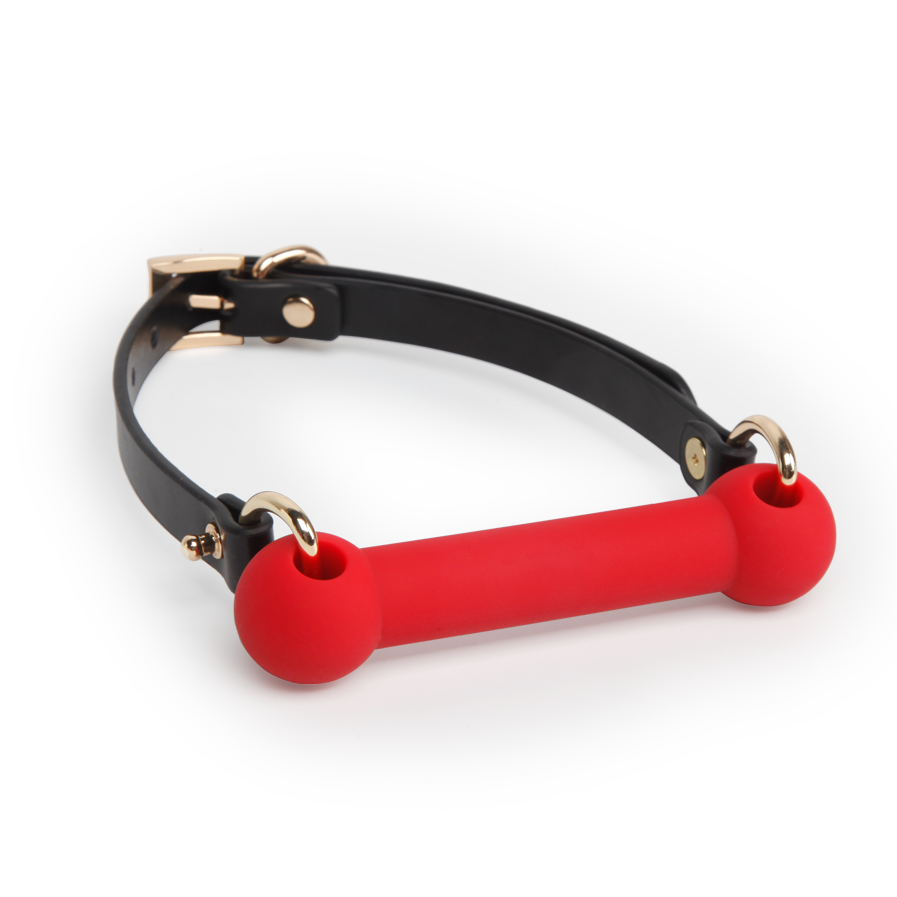 red silicone mouthpiece with black leather strap showing flexible restraint fit
