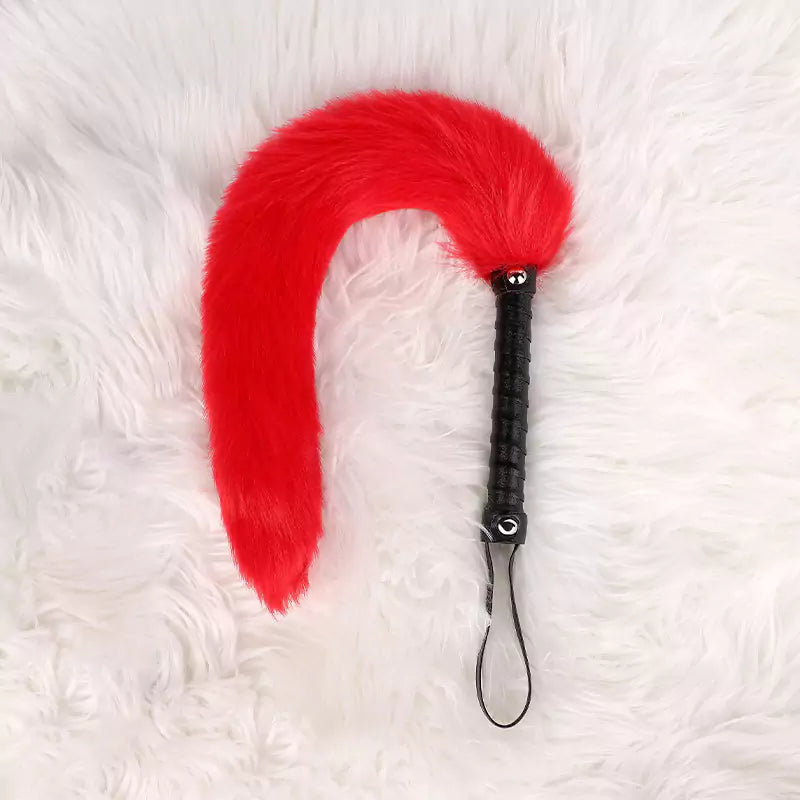 Red faux fur tail with black handle detail