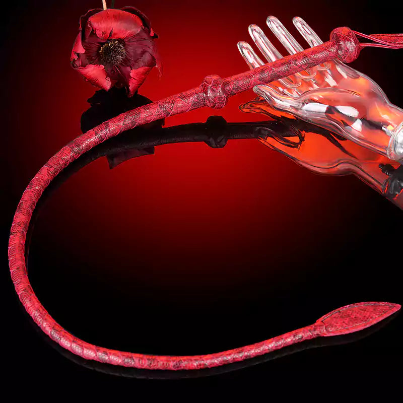 Handwoven red whip full view in dramatic red backdrop