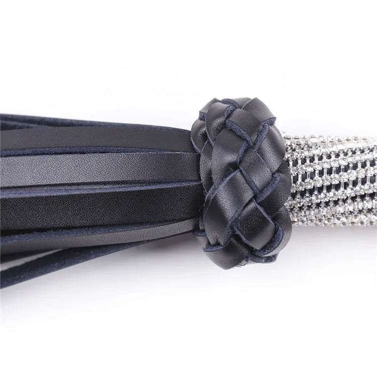 Close-up detail of rhinestone handle and leather tails