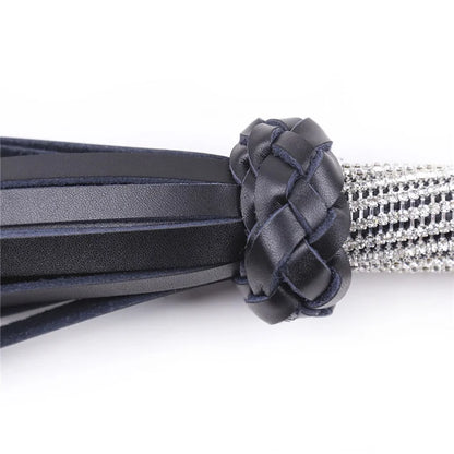 Close-up detail of rhinestone handle and leather tails