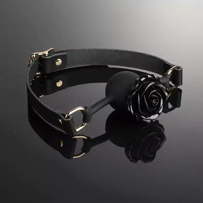 Rose silicone ball gag displayed in a styled product setting