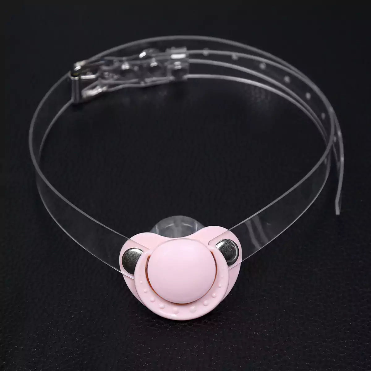 Pink silicone pacifier restraint gag with clear PVC strap