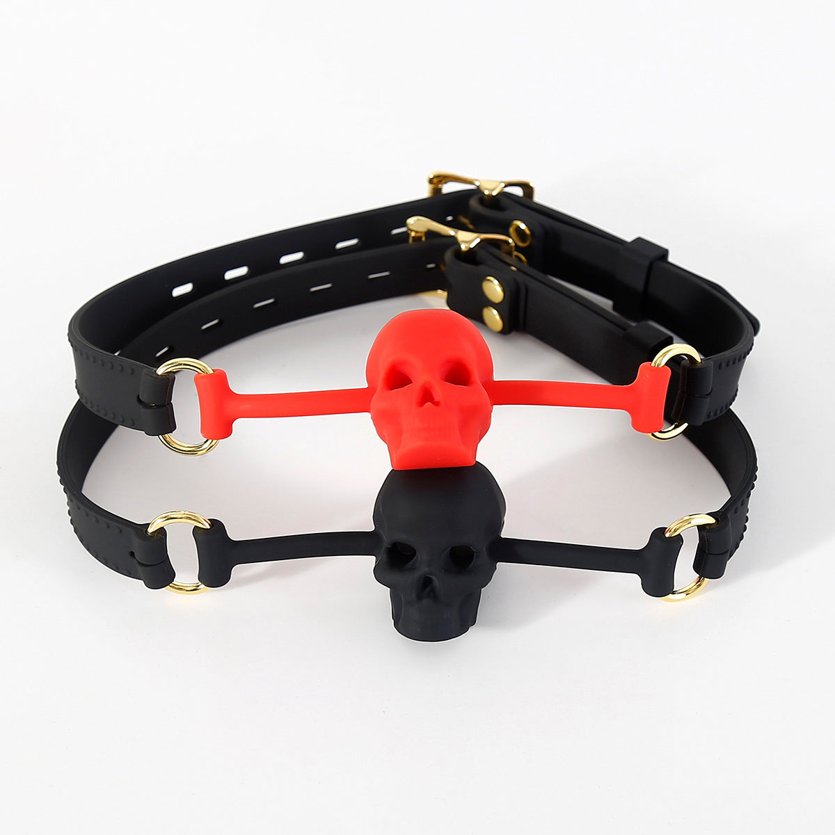 Black and red silicone skull ball gags displayed together showing both color options and vented skull mouthpiece design