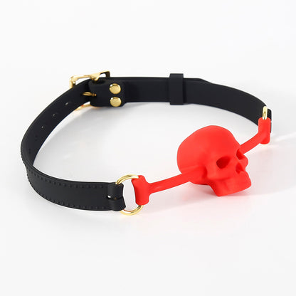 Close-up detail of the vented skull-shaped silicone mouthpiece on the BDSM ball gag