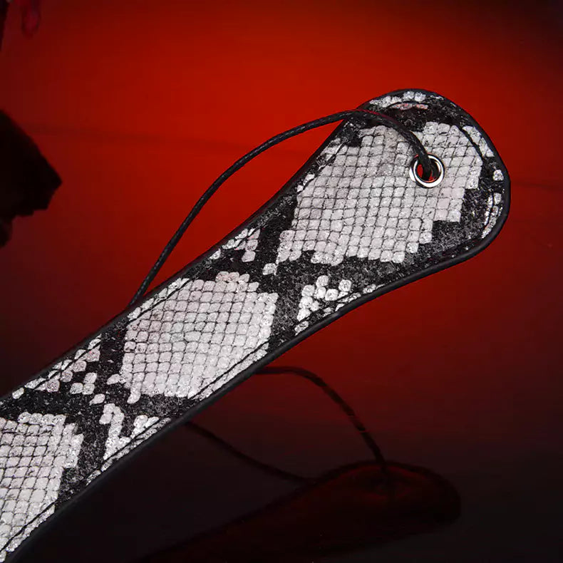 Snake pattern hand spanker paddle handle detail close view