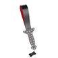 Studded leather slapper paddle on white background