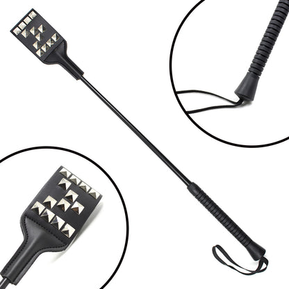 Close-up of letter M stud pattern on studded faux leather riding crop