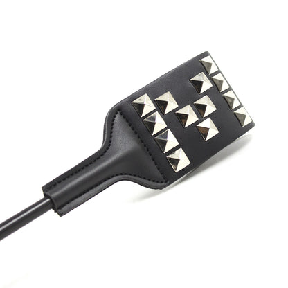 Close-up of metal stud pattern on faux leather striking face