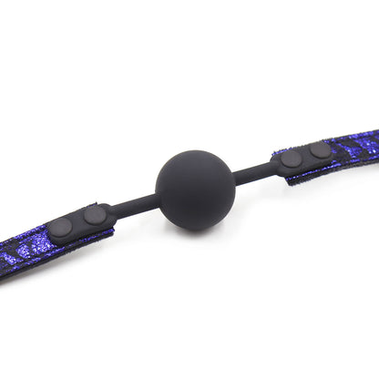 Close-up detail of the silicone ball and plush suede inner strap on the ball gag