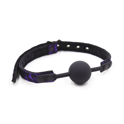 Purple suede-lined silicone ball gag with plush suede inner strap displayed on a clean white background