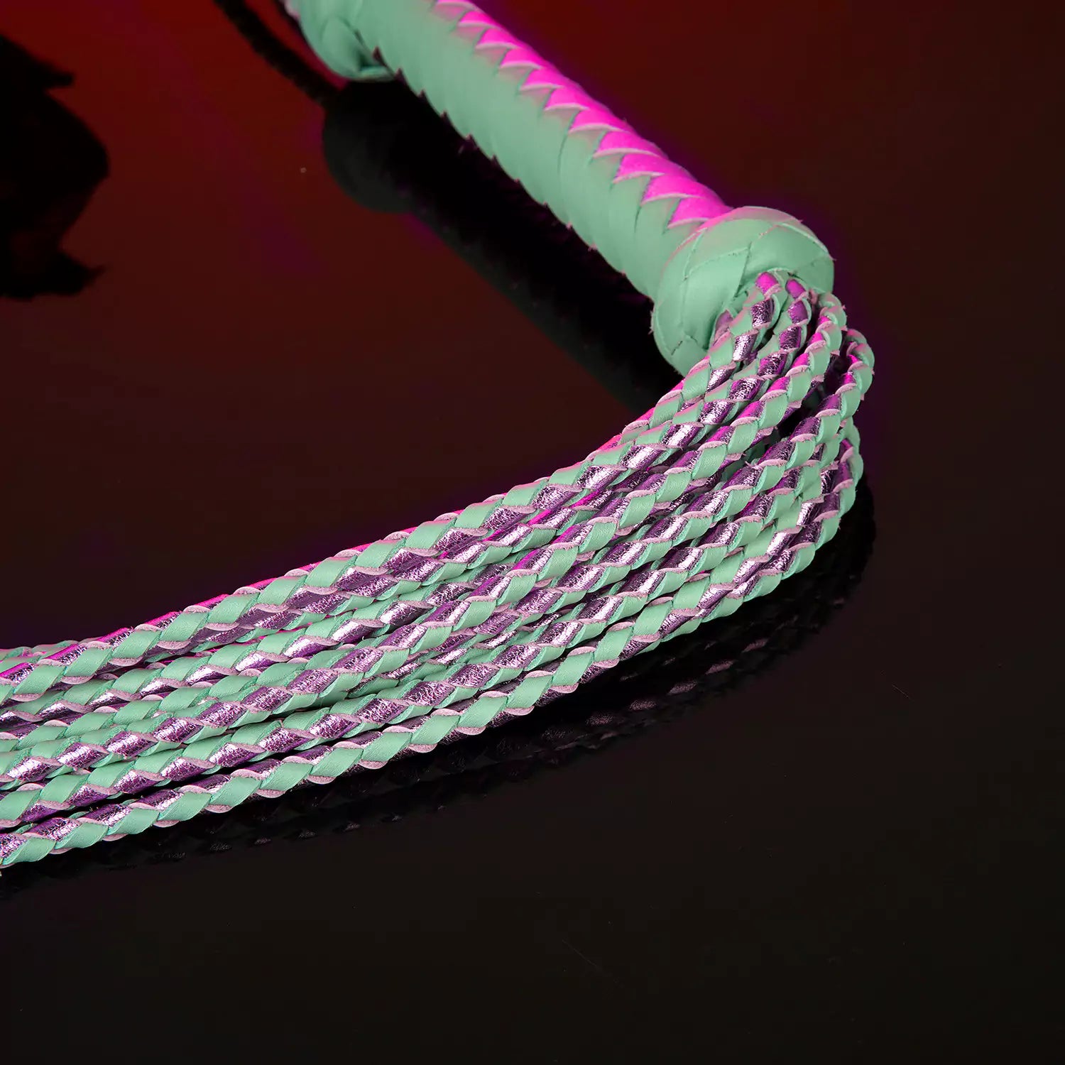 detailed view of tassel base and raised-end leather handle construction