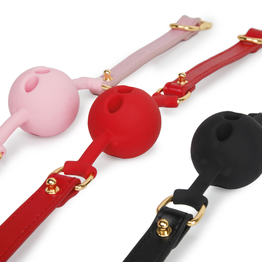 pink red and black silicone ball gags displayed together for color comparison