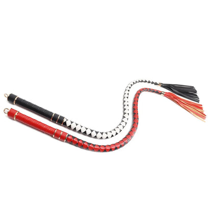 Two-tone braided BDSM whip laid out fully extended view