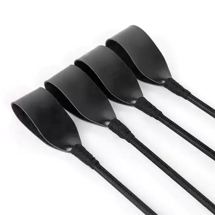 Close-up of woven striking head on vintage black long-handle riding crop
