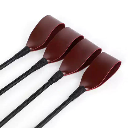 Close-up of woven head on vintage burgundy riding crop