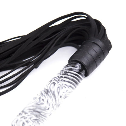 Close-up of wave-textured glass handle on leather flogger