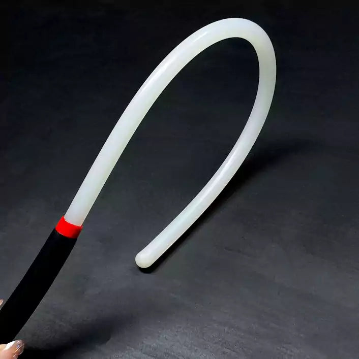 Close-up detail of white acrylic discipline cane showing clean smooth surface