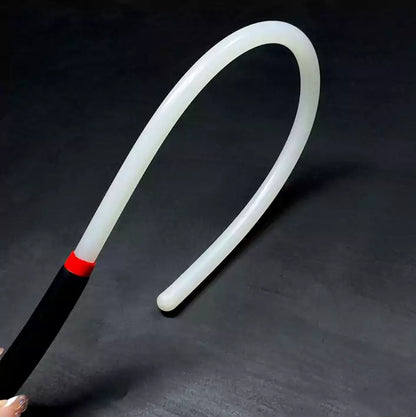 Close-up detail of white acrylic discipline cane showing clean smooth surface