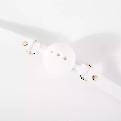 Close-up detail of the white breathable ball gag