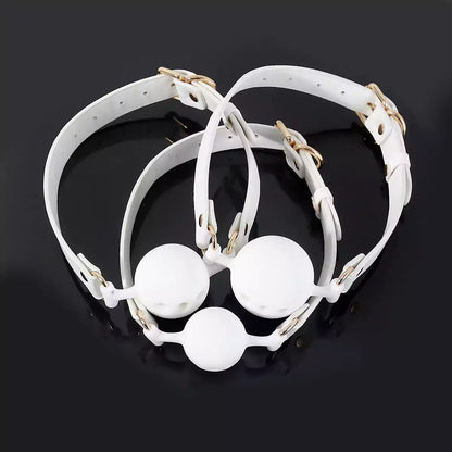 White breathable ball gag displayed in a styled product setting