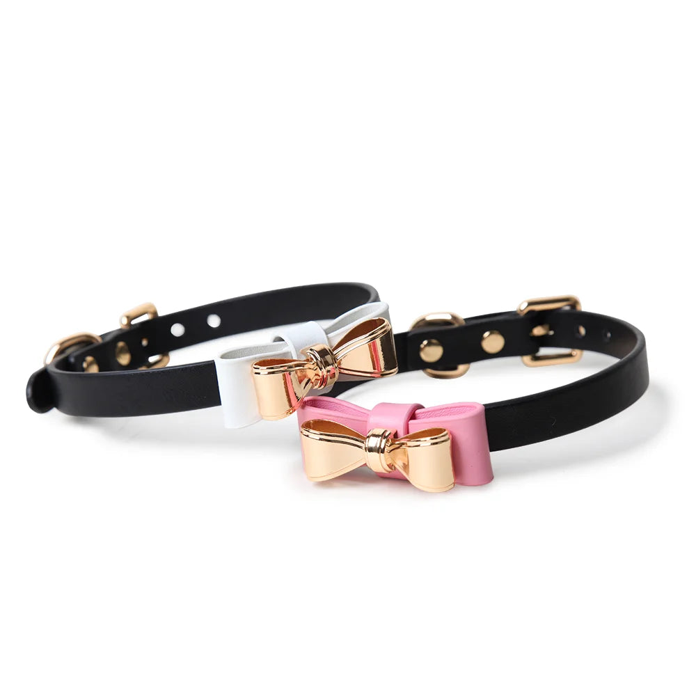 White and pink leather collars with gold bow full view
