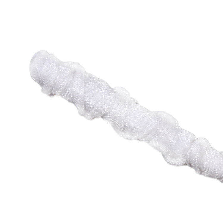 Close-up of ribbon-wrapped handle on white studded BDSM riding crop