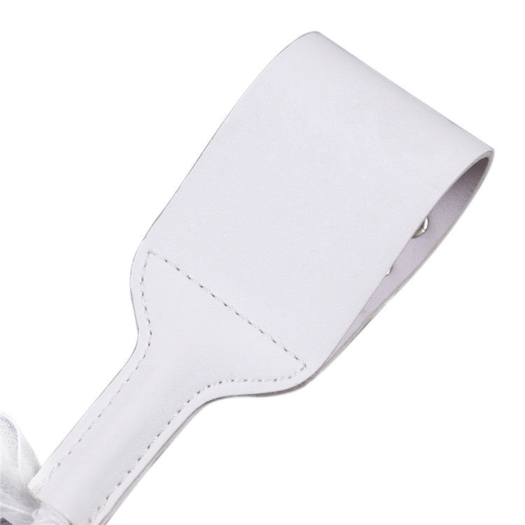 Back surface detail of white studded riding crop paddle head