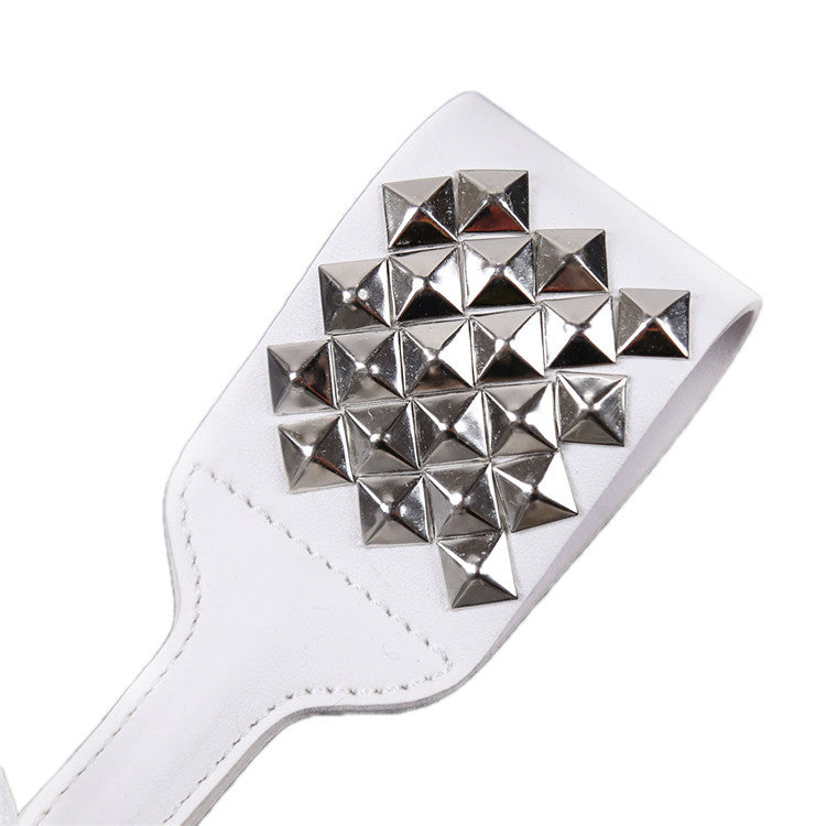 Close-up front view of silver studded white faux leather paddle head