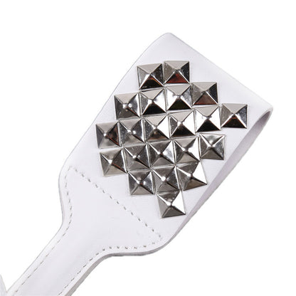 Close-up front view of silver studded white faux leather paddle head