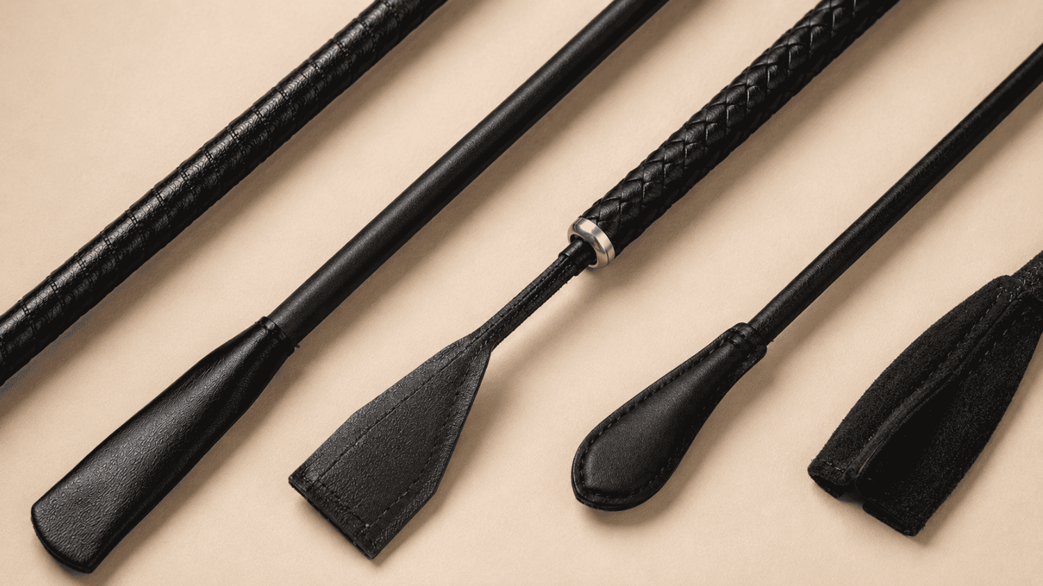 Leather riding crops with wrapped shaft, synthetic core, and stable flex.