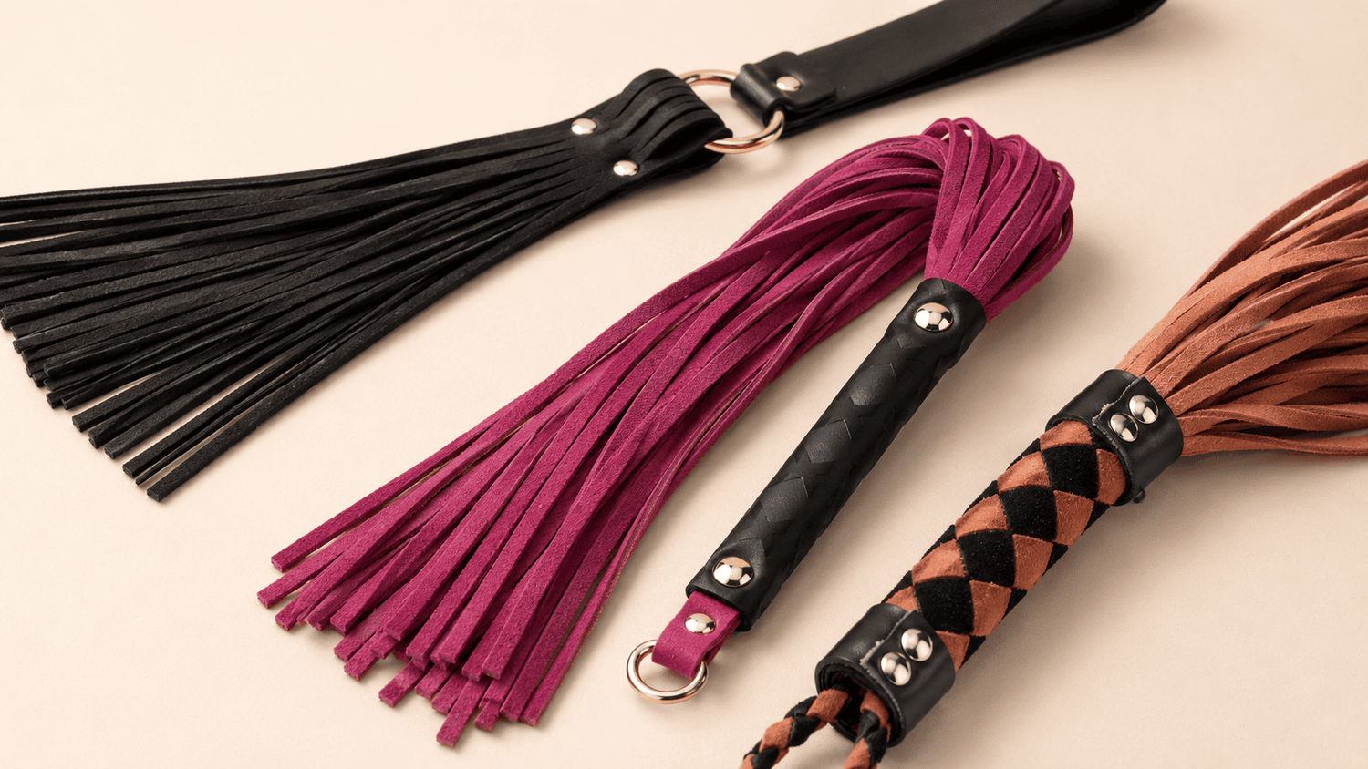 Mini floggers with leather, suede, or rope tails and compact handles.
